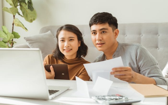 Young family discussing family finances - Oasis Credit